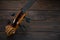 A fragment of a cello lies on a wooden surface. Place for text