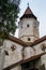 Fragment of the church and the watchtower with the clock of the Fortified Church Prejmer in Prejmer city in Romania