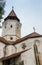 Fragment of the church and the watchtower with the clock of the Fortified Church Prejmer in Prejmer city in Romania