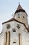 Fragment of the church and the watchtower with the clock of the Fortified Church Prejmer in Prejmer city in Romania