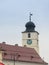Fragment of the clock tower of the Roman Catholic Church of the Holy Trinity on the Large Square in Sibiu city in Romania