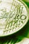 Fragment of a coin of 1 one euro. In focus inscription with the name of the Eurozone currency. Close-up. Vertical green tinted