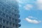 Fragment of concrete metal structures on a background of blue sky with clouds. Construction of a multi-level parking, residential