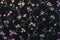 Fragment of a decorative panel with a floral pattern. Floral background for design and decoration. Flowers on a black background