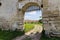 Fragment of defense stone wall with entrance in mediaeval castle