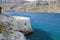 Fragment of a defense tower and walls in the Spinalonga fortress. Sea view from the leper island in Greece