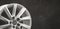 fragment detail of a new aluminum alloy wheel in silver color copy space