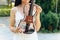 A fragment of an electric violin, a violin in the hands of a musician\'s girl.