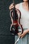 A fragment of an electric violin, a violin in the hands of a musician\'s girl.