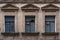 Fragment of the facade of an abandoned building with three windows