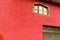 Fragment of the facade of a beautiful red Spanish house.