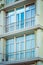 Fragment of the facade of a modern apartment house with a window and a balcony