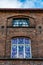 Fragment of a facade of an old, ruined textile factory with painted windows