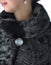 Fragment of female fur coats black.