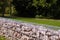 A fragment of a fence made of gabions. Separation of the street from the park area