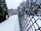 Fragment of the fence. Wire mesh fence. Winter season.