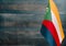 Fragment of the flag of the Comoros in the foreground blurred light background copy space