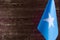 Fragment of the flag of the Federal Republic of Somalia in the foreground space for text blurred background