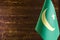 Fragment of the flag of the Islamic Republic of Mauritania in the foreground space for text blurred background