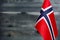 Fragment of the flag of the Kingdom of Norway in the foreground blurred background copy space