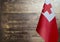 Fragment of the flag of the Kingdom of Tonga in the foreground blurred wooden background Kopi space