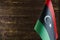 Fragment of the flag of the state of Libya in the foreground space for text blurred background