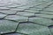 Fragment of green shingle tile texture roof for background