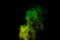 Fragment of green yellow steam smoke isolated on a black background, close-up. Create mystical Halloween photos