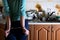 Fragment of the handcuffed female body at the kitchen counter, f