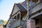 A fragment of a house with a balcony with a carved railing of dark wood