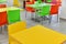 Fragment of interior cafe with bright tables and plastic chairs