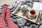 Fragment of legs in red striped socks. interior and home coziness concept. Top view. A cup of tea, a teapot with herbal tea, sugar