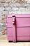 A fragment of a massive pink wooden chest in vintage style