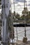 Fragment of a mast rigging a sailing yacht against the background of a river and cloudy sky. Close-up