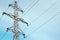 Fragment metal power pole and wires against the sky