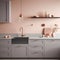 Fragment of modern classic kitchen. Gray facades and countertop with built-in sink and gold faucet. Peach wall with open