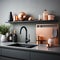 Fragment of modern minimalist kitchen. Gray facades, wall and countertop with built-in sink and black faucet. Wall shelf