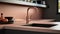 Fragment of modern minimalist kitchen. Stone peach countertop with built-in sink and copper faucet. Peach backsplash