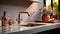 Fragment of modern minimalist luxury kitchen. Gray countertop with built-in sink and chrome faucet. Dusty pink