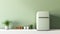 Fragment of modern Scandi style kitchen with green wall and green retro fridge. White countertop and facades. Green