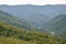 Fragment of the mountainous terrain in the Carpathians, Ukraine. The forest is forgiven by the reliefs of the Carpathian Mountains