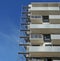 Fragment of a new inhabited apartment house and metal building c