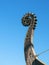 Fragment of the nose of a medieval viking ship against the blue sky