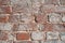 Fragment of old brick wall crumbling