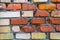 A fragment of an old brick wall in orange red and yellow colors.Texture, background.