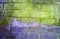 Fragment of old dirty brick wall with peeling plaster texture white grey brown black green blue lime yellow orange maroon violet p