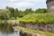 Fragment of the old fortress, stone wall and part of the tower surrounded by water