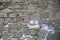 Fragment of an old fortress wall with traces of snow as the basis of the background.