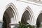 A fragment of an old Gothic-style stone wall with arches and columns in Vienna, Austria.