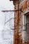 Fragment of the old Russian prison building: window with barbed wire-vertical photo